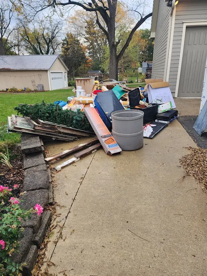 Dumpster being loaded with debris for Commercial Dumpster Rental in Perry